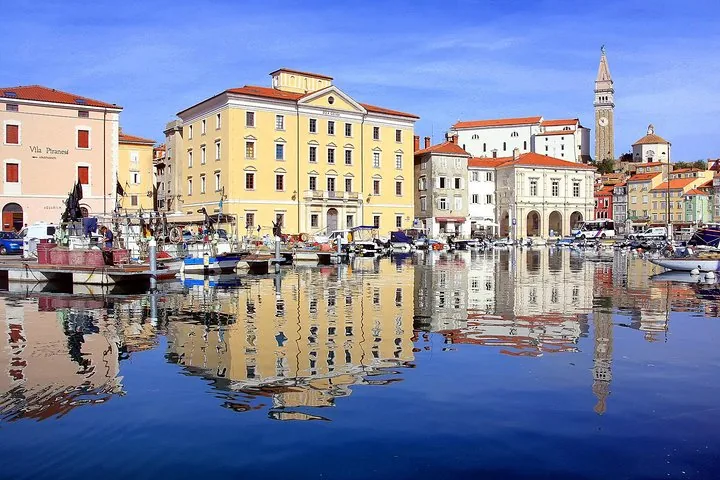 Coastal town with colorful buildings reflecting in the calm water